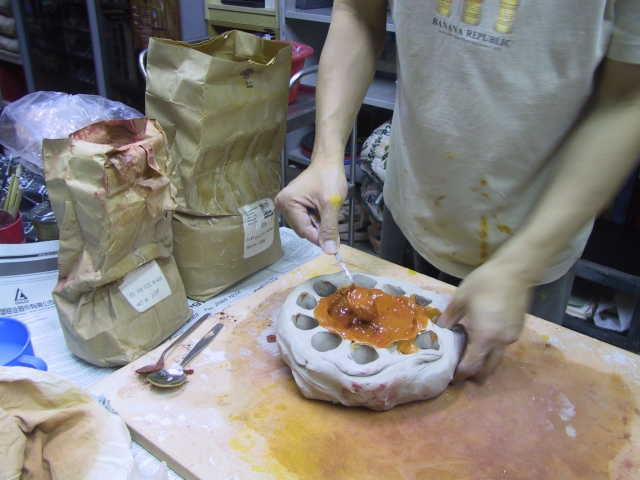 Preparing clay with iron oxide for skin color